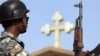 Iraq -- A policeman stands guard outside a church in the Baghdad district of Dora, 14Oct2008