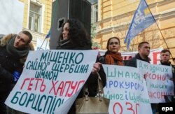 Ukrainian activists hold placards during their rally in front of the presidential office in Kyiv, demanding the resignation of Prosecutor-General Viktor Shokin.