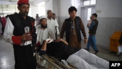 FILE: Pakistani medics move an injured security personnel for a treatment at a hospital in Peshawar on February 15.