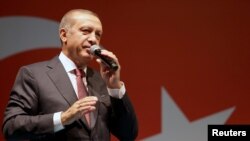 Turkish President Tayyip Erdogan addresses his supporters outside of his residence in Istanbul, Turkey on July 19.