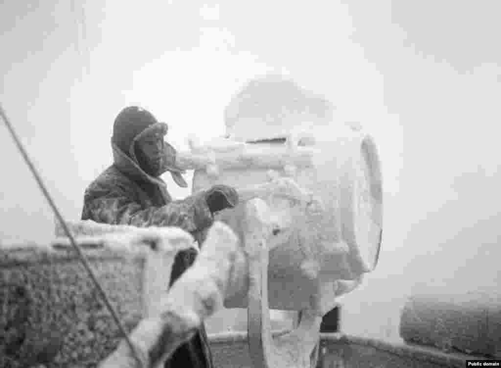 Ice forms on a signal projector on the cruiser &quot;HMS Sheffield&quot; on an Arctic convoy to Russia.