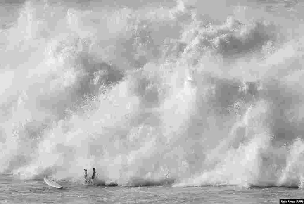 A surfer wipes out while taking part in the Arnette Punta Galea Big Wave World Tour in the northern Spanish Basque town of Getxo. (AFP/Rafa Rivas)