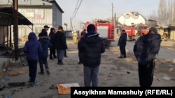 Locals inspect damage in the Kazakh village of Masanchi after ethnic clahsed erupted there at the weekend. 