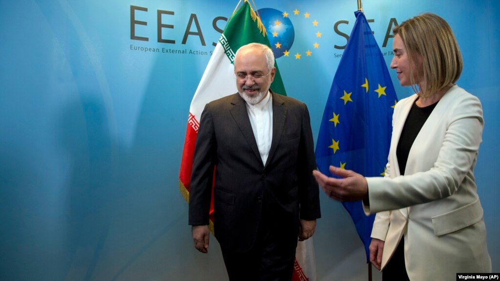 European Union High Representative Federica Mogherini, right, greets Iran's Foreign Minister Mohammad Javad Zarif prior to a meeting in Brussels on Monday, March 16, 2015.