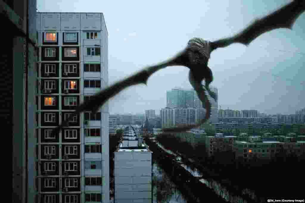 A Game of Thrones dragon swoops past a Soviet-era apartment block. 