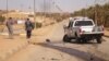 Iraqi police inspect the site of militant attack in the town of Haditha on March 5.