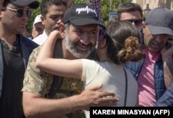 Opposition leader Nikol Pashinian is embraced by a supporter as he takes part in a rally in Yerevan on May 2.