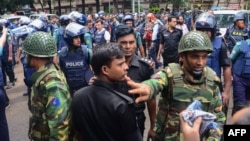 Bangladeshi police and military gather in an intersection near an upscale restaurant after a bloody siege ended in Dhaka on July 2.