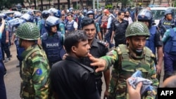 Bangladeshi police and military gather in an intersection near an upscale restaurant after a bloody siege ended in Dhaka on July 2. 