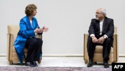 EU High Representative for Foreign Affairs Catherine Ashton (left) speaks with Iranian Foreign Minister Mohammad Javad Zarif at the start of two days of closed-door nuclear talks in Geneva. 
