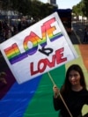 SERBIA -- A participant holds a banner reading 'Love is love' during the Belgrade Pride Parade march in Belgrade, Serbia, 15 September 2019. 