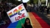 SERBIA -- A participant holds a banner reading 'Love is love' during the Belgrade Pride Parade march in Belgrade, Serbia, 15 September 2019. 