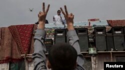 Imran Khan addresses supporters outside the parliament building in Islamabad on August 28.