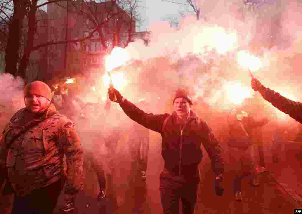 Members of the Ukrainian volunteer battalion Azov hold flares during a protest outside the Ukrainian Security Services (SBU) prison in Kyiv on March 1. The protesters were demanding the release of Stanislav Krasnov, the head of the nationalist organization Azov-Crimea, who has been accused of spying for Russia.&nbsp;