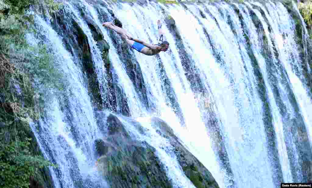 A competitor takes part in the annual international waterfall-jumping competition held in the old town of Jajce, Bosnia-Herzegovina, on August 17. (Reuters/Dado Ruvic)