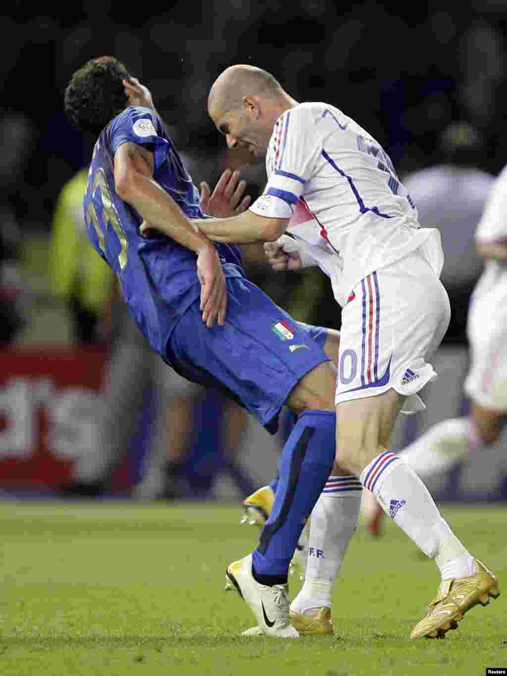 Italy's Marco Materazzi falls on the pitch after being head-butted by France's Zinedine Zidane (R) during their World Cup 2006 final soccer match in Berlin July 9, 2006. REUTERS/Peter Schols/GPD/Handout
