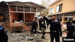 Pakistani police secure the site of a bomb attack at the district court in Islamabad on March 3.