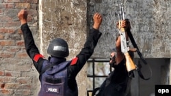 Pakistani police commandos react after they killed four militants and arrested three others in Lahore on March 30.