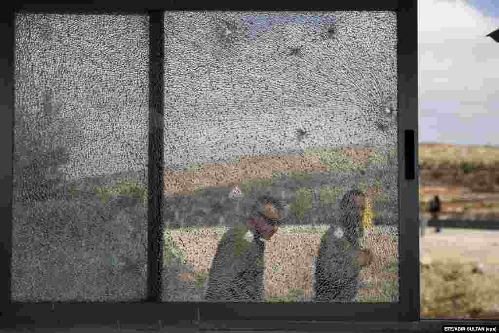 A window is shattered by bullets following a shooting incident at the entrance to the Jewish settlement of Har Adar, near Jerusalem, in the West Bank on September 26. (epa-efe/Abir Sultan)