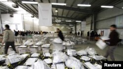 Kosovo -- Election officials carry ballot boxes from the country's first parliamentary elections since independence at the Kosovo Election Commission counting center in Pristina, 13Dec2010