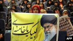 An Iranian girl holds up a portrait of Supreme Leader Ayatollah Ali Khamenei during a campaign meeting for conservatives ahead of upcoming parliamentary elections, which could shape Iran's political landscape for years to come. 