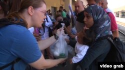 Thousands of beleaguered refugees and migrants were given food and water as they disembarked from trains in Munich and Vienna on September 1.