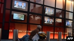 A man watches the first presidential debate between Democratic President Barack Obama and Republican challenger Governor Mitt Romney in front of an office building along Sunset Boulevard in Hollywood, California on October 3.