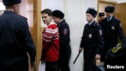 Ukrainian military pilot Nadia Savchenko (second from left) is escorted inside a court building as she attends a hearing in Moscow on March 4.