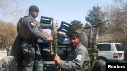 Afghan policemen arrive at the site of a blast in Kabul on March 21.