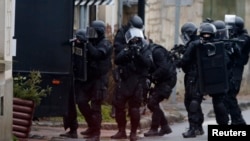 French special intervention police conduct a house-to-house search in Longpont, northeast of Paris on January 8, 2015.