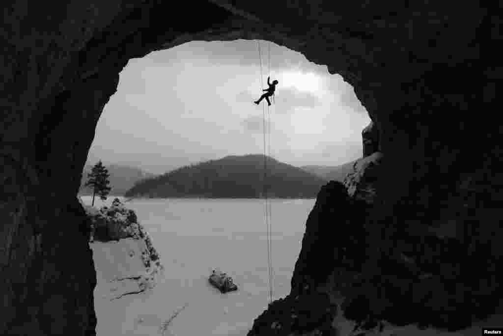 Rescuer Yulia Borisova takes part in a rock-climbing evacuation training session on the Tsarskie Vorota (Tsar Gate) rock on the bank of the frozen Biryusa Bay of the Yenisei River near Krasnoyarsk, Siberia. (Reuters/Ilya Naymushin)