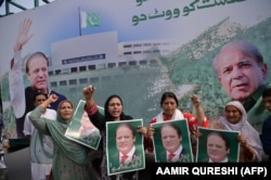 Supporters of ousted Prime Minister Nawaz Sharif gather at the venue where his younger brother, Shehbaz Sharif, will lead a rally toward the airport ahead of Nawaz Sharif's arrival from London in 2018.