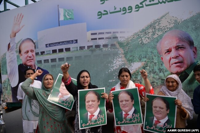 Supporters of ousted Prime Minister Nawaz Sharif gather at the venue where his younger brother, Shehbaz Sharif, will lead a rally toward the airport ahead of Nawaz Sharif's arrival from London in 2018.