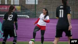 Former Afghanistan women's football captain Khalida Popal (center) has spoken out previously about the discrimination women players face.