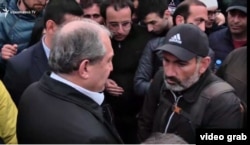 President Armen Sarkisian (left) talks with opposition leader Nikol Pashinian in Republic Square on April 21.