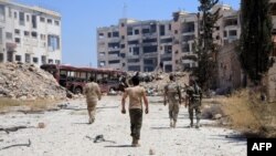 Syrian Army soldiers patrol an area on the outskirts of Aleppo.