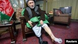 Ahmad Ishchi displays an injury on his leg during an interview at his home in Kabul on December 13.