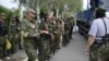 Pro-Russian separatists of the self-proclaimed &quot;Vostok Battalion&quot; preparing to board a truck at a checkpoint on the outskirts of the city of Donetsk on May 25.