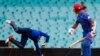 Afghanistan&#39;s Nawroz Mangal (right) watches as England&#39;s wicketkeeper Jos Buttler unsuccessfully tries to stop a boundary during their Cricket World Cup match in Sydney on March 13. (Reuters/David Gray)