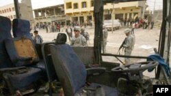 A U.S. soldier looks at a wrecked bus hit by a suicide bomber in Kirkuk.