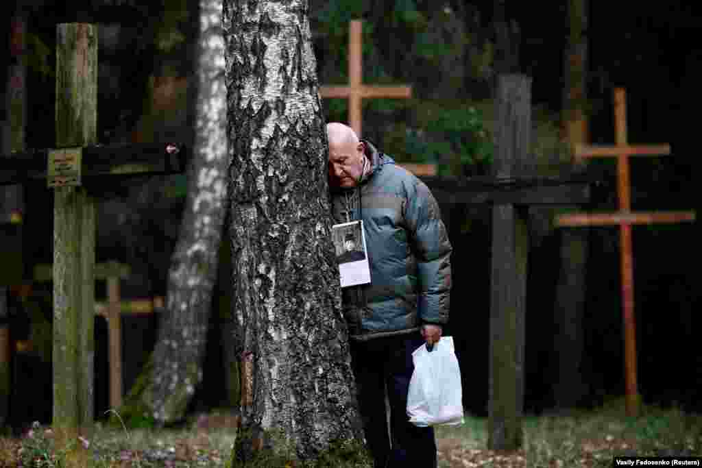 A man pauses to reflect at a mass grave at Kurapaty, near Minsk, on November 5, in memory of the thousands of people who were executed there by the Soviet secret police. At least 30,000 people were killed and buried at the Kurapaty preserve by the Soviet authorities under dictator Josef Stalin in the 1930s and &#39;40s. (Reuters/Vasily Fedosenko)