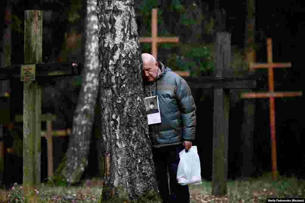 A man pauses to reflect at a mass grave at Kurapaty, near Minsk, on November 5, in memory of the thousands of people who were executed there by the Soviet secret police. At least 30,000 people were killed and buried at the Kurapaty preserve by the Soviet authorities under dictator Josef Stalin in the 1930s and '40s. (Reuters/Vasily Fedosenko)