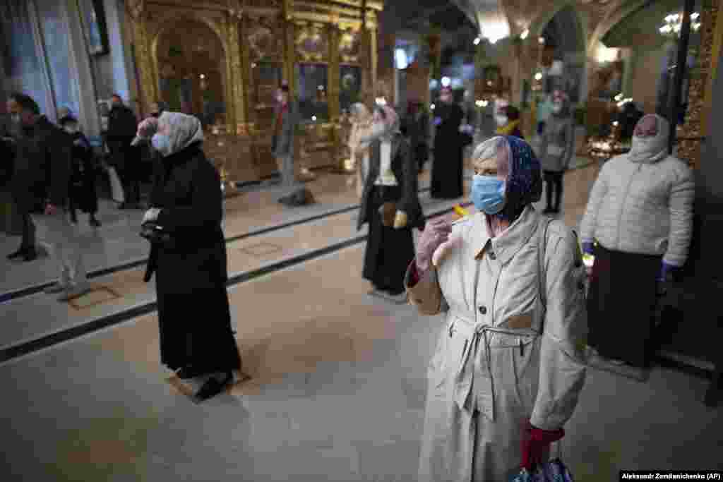 Parishioners observing social-distancing guidelines cross themselves as they attend service at the Epiphany Cathedral in Moscow on June 2. (AP/Aleksandr Zemlyanichenko)