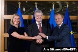 EU foreign policy chief Federica Mogherini (left), Ukrainian President Petro Poroshenko (center), and the president of the European Council, Donald Tusk, in Brussels on December 12