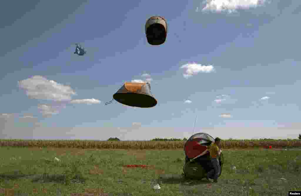 Migrants' tents are blown away by the wind near a collection point in the village of Roszke, Hungary. (Reuters/Marko Djurica)