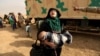 A woman fleeing fighting between Islamic State militants and Iraqi forces in eastern Mosul reacts as she heads to safer territory on November 8.