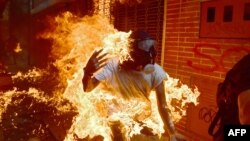 A demonstrator catches fire during clashes with riot police within a protest against Venezuelan President Nicolas Maduro in Caracas in May.
