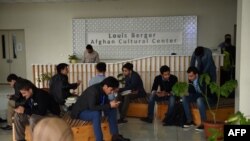 FILE: Afghan students from the American University of Afghanistan wait for the start of classes at the beginning of a new term in Kabul in March.