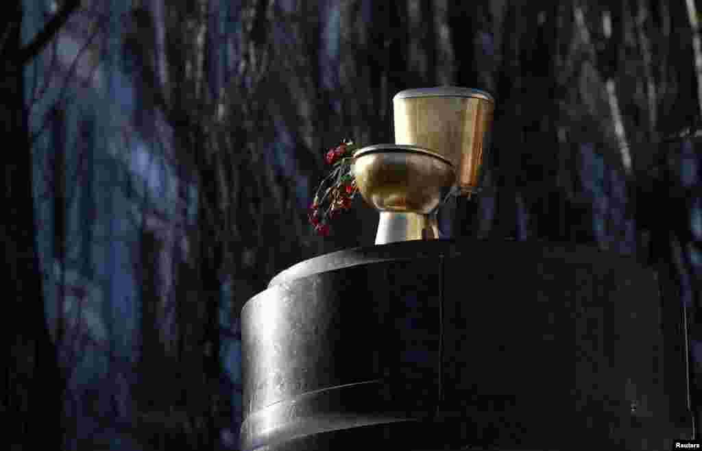 A golden toilet bowl is seen on the pedestal for a statue of Soviet state founder Vladimir Lenin, which was toppled by antigovernment protesters in Kyiv in December. (Reuters/David Mdzinarishvili)