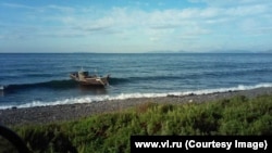 A fishing boat rolling in the waves after it drifted to shore near the town of <a href="https://www.google.com/maps/place/Zarubino,+Primorsky+Krai,+Russia,+692725/@42.6606725,131.0952789,471m/data=!3m1!1e3!4m5!3m4!1s0x5fb44b3e34a489a7:0x56e0e6927d0442eb!8m2!3d42.647737!4d131.0770297" target="_blank">Zarubino</a> on August 30.